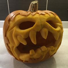 a carved pumpkin with teeth and fangs on it