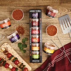 the contents of an assortment of spices and seasonings on a wooden table with utensils