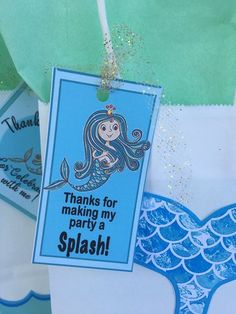 there is a blue and white bag with a tag on it that says thanks for making my party a splash