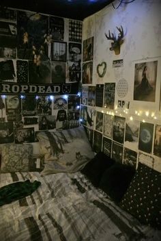 a bed room with a lot of pictures on the wall and lights strung from the ceiling