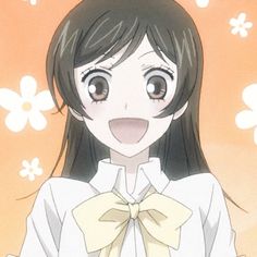 a girl with long black hair wearing a white shirt and yellow bow tie