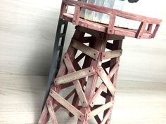 a small wooden tower sitting on top of a table