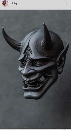 a black mask with horns on top of it's head and an evil face