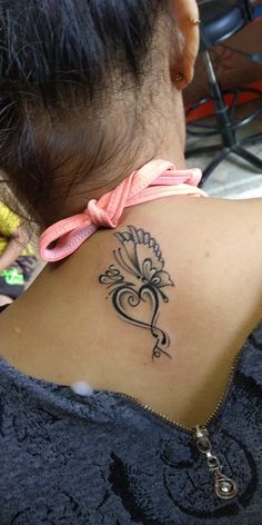 a woman with a tattoo on her back neck