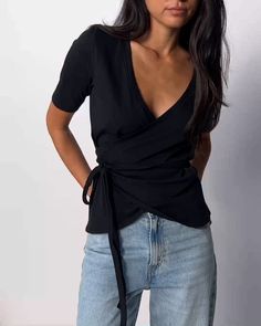 Because everyone needs an effortless wrap tee in their rotation. With a fully adjustable fit and a relaxed V neck, it's the perfect pair with your favorite vintage jeans for an easy off-duty outfit. (This one comes in Jet Black.) | Women's Bianca Tee Top in Jet Black | Ethical Essentials Casual Fitted Wrap Tops, Casual Fitted Short Sleeve Wrap Top, Casual Wrap Top For Day Out, Casual V-neck Wrap Top For Day Out, Versatile Fitted Wrap Top With Short Sleeves, Versatile Fitted Short Sleeve Wrap Top, Spring Casual Wrap Top With Short Sleeves, Short Sleeve Wrap Top For Day Out, Casual Wrap Top With Short Sleeves For Spring