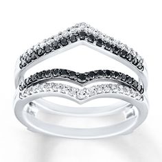 a white gold ring with black and white diamonds