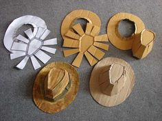 several different hats are arranged on the floor next to each other, including paper and cardboard