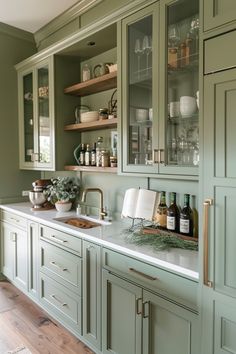 a kitchen with green cabinets and white counter tops