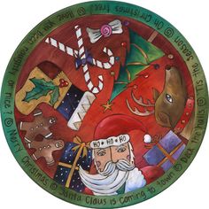 a plate with an image of santa claus and other christmas items on it, all painted in different colors