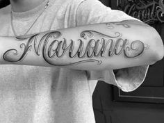 a man with a tattoo on his arm that says,'romano'in cursive script