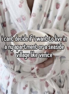 someone is holding a cup in their hand with the words i can't decide if i want to live in a ny apartment or a seaside village like venice