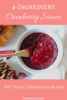 the ingredients for cranberry sauce in a white bowl with a spoon and pine cones