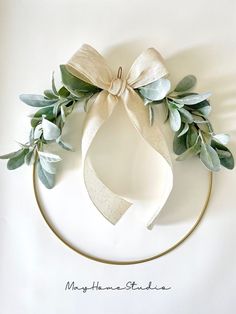 a white plate topped with a bow and greenery