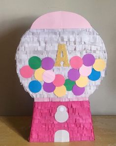 a pink and white paper machine with the letter a on it's front side