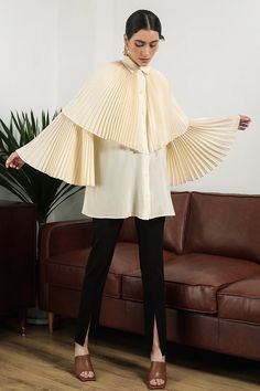 The blouse is impressive with a pleated cape and sleeves design symbolizing the wings that bring freedom in fashion. Special silk material is used for creating a soft look and bringing a relaxed feeling to the wearer. Note:*Processing time takes 7-10 working days (including 3-5 working days for manufacturing and NOT including shipping time)**Backorder Definition- The product is low in stock and in case the customer purchased successfully after out of stock, the order will need time to restock.- Elegant Workwear Capelet With Cape Sleeves, Chic Capelet For Workwear, Elegant Capelet With Cape Sleeves For Workwear, Chic Capelet With Cape Sleeves For Work, Spring Workwear Cape, Chic Cape For Workwear, Elegant Spring Cape For Workwear, Chic Long Sleeve Cape For Work, Elegant Cape Top For Spring