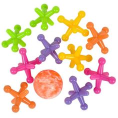 an assortment of colorful plastic toys on a white background