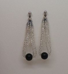 Silver Black Beaded Earrings. Silver Seed Beads Strung Joined by a Larger Black Bead. 2 inch Length Evening Beaded Earrings With Round Beads, Beaded Evening Earrings, Evening Earrings With Dangling Round Beads, Black Beaded Chain Dangle Earrings, Black Beaded Chain Earrings As A Gift, Elegant Silver Beaded Chain Earrings, Black Beaded Earrings For Evening, Black Earrings With Silver Beads As Gift, Black Beaded Dangle Earrings With Beaded Chain