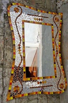 a mirror that is sitting on the side of a wall with a reflection in it