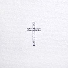 a cross drawn on the side of a white wall