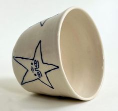 a ceramic cup with a star design on it