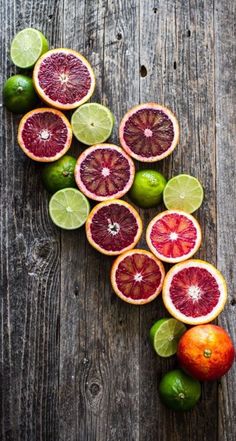 grapefruits and limes arranged in the shape of a heart