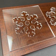 two cookie cutters sitting on top of a wooden cutting board