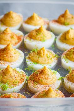 deviled eggs with mustard and seasoning in a baking pan