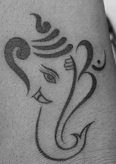 an elephant tattoo on the leg of a woman's leg, which is drawn in black ink