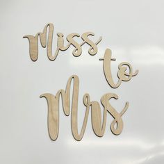 wooden cutouts with the words miss to mrs written in cursive font on a white background