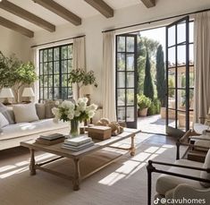 a living room filled with furniture and lots of windows