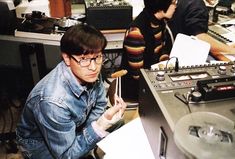 a man sitting in front of a record player