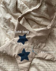 a star tote bag is laying on a bed with the words, star tote bag