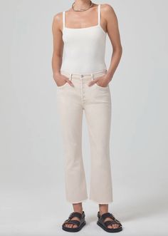 The Isola features a flattering mid rise with a close fit through the leg and subtle bootcut flare. This cropped fit hits right above the ankle, making them the perfect pair to show off your shoe of choice. This transitional style is sure to be your new closet staple. This fit is true to size. Medium to light beige with frayed hem Comfort stretch denim with a super soft luxurious hand for all day wearability Closure: Zip Fly Rise: 11 1/4" Inseam: 26 1/2" Leg Opening: 16 1/2" Fabric: 59% Organic New Closet, Loungewear Shorts, Citizens Of Humanity, Summer Baby, Transitional Style, Cut Jeans, Denim Shop, Light Beige, Jeans And Boots