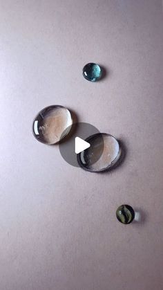 three different colored stones sitting on top of a table