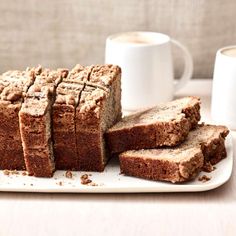 sliced brownies on a plate with two cups of coffee