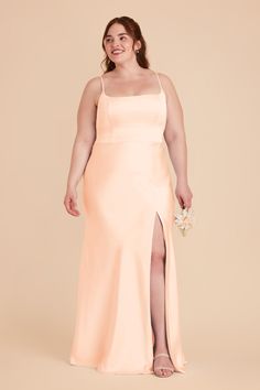 a woman in a long peach dress