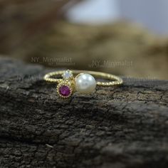 The ring made with genuine ruby gemstone & SI clarity G-H color diamond and 14K solid yellow gold * SKU: SGR00976 * Made to Order * Gold Purity: 14K Solid Yellow Gold (stamped) * Custom Gold Color: Rose Gold, Yellow Gold, White Gold * Custom Gold Purity: 9K/14K/18K (Charges Apply) * Diamond 100% Genuine Diamond * Diamond Weight: 0.35 ct. * Diamond Color: G-H color * Diamond Clarity: SI1- SI2 * Diamond Cut: Brilliant Cut (Excellent) * Pearl Weight: 0.45 ct. * Ruby Weight: 0.15 ct. Product Mea Gold Diamond Ring With Lab-created Ruby Birthstone, Yellow Gold Ruby Birthstone Ring In Cubic Zirconia, Yellow Gold Ruby Birthstone Ring With Cubic Zirconia, Dainty Gold Ruby Ring With Diamond, Diamond Engagement Band, White Diamond Earrings, Moonstone Engagement, Moonstone Engagement Ring, Bar Stud Earrings