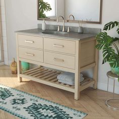 a bathroom with a sink, mirror and rug