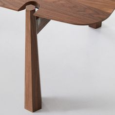 a wooden table with an unusual design on it's top and bottom part,