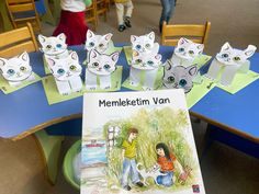 children's book about memekettim van with paper cats on the table