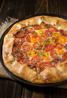 a pizza sitting on top of a pan covered in toppings