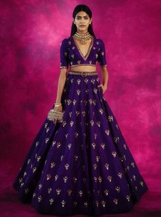 Editor's Note This set features a fully hand embroidered chand jaal with sequim cut dana skirt and v- neck crop top set. Fabric: Raw Silk Color: Purple Care: Dry Clean Only About the Designer Vvani by Vani Vats- an Indian ethnic women’s wear label. It is a depiction of the royal and intricate handcrafted embroideries in unconventional designs. Vani Vats, Purple Lehenga, Blouse Lehenga, Simple Lehenga, Sari Design, Indian Outfits Lehenga, Wedding Lehenga Designs, Lehenga Designs Simple, Traditional Indian Dress