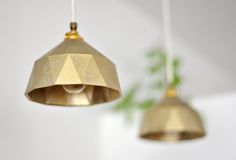 two brass colored lights hanging from the ceiling