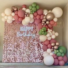 a birthday backdrop with balloons and confetti