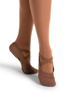 a woman's feet wearing ballet shoes with straps on the toes and one foot in brown