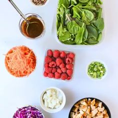 the ingredients for this salad are laid out in bowls