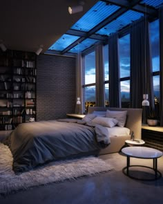 a bedroom with a large bed and lots of books on the shelves next to it