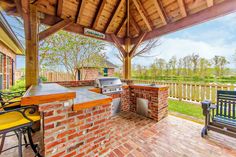 Discover our approach to outdoor kitchen spaces where functionality meets the rustic allure of timber framing. Concrete Edging, Outdoor Cooking Spaces, Luxury Landscaping, Brick Patios