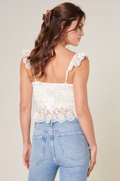 Feel the sun on your skin in this charming ruffled crop top. Embroidered daisies shape this cropped top, featuring ruffle straps that join a fitted bodice with a sweetheart neckline. It maintains a shapely fit with a peplum ruffle along the waistline. A tie front detail sits at the heart of the neckline to create a flirty flair. Wear it with your favorite high rise bottoms for a finished look.- Hook and eye closure- Tie front detail- Embroidered- Peplum- Color: White FloralSize + Fit - Model is Front Tie Crop Top, Embroidered Daisies, Ruffled Crop Top, Natural Hair Removal, Tie Crop Top, White Crop Top, Hook And Eye, Cropped Top, Fitted Bodice