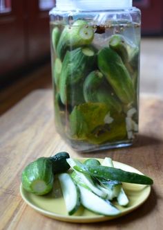 pickles and cucumbers in a jar on a table